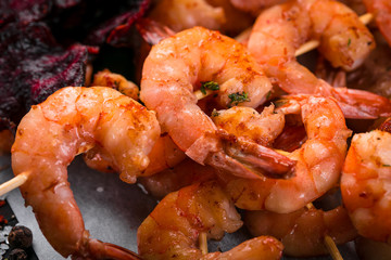 grilled shrimp skewers on a dark background