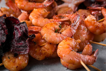 grilled shrimp skewers on a dark background