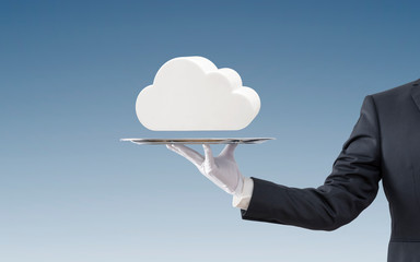 Businessman offering white cloud on silver tray over blue background 