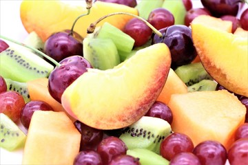 Closeup of a fresh colorful fruit salad as background