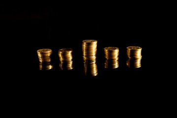 Stacks of coins on the black background
