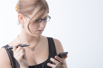 young woman with glasses is working with a calculator