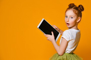 Happy child with tablet computer. Kid showing
