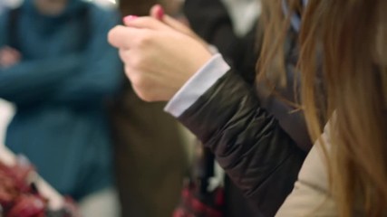 Pretty young women try liquid lipstick color on her hand, show it to her friend
