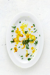 Dirty empty white plate on a white background top view