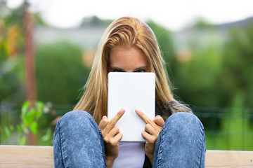 Young woman making a rude sign with her finger