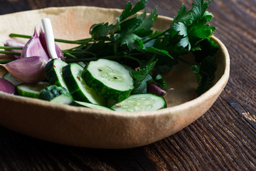 Bowl of freshly picked organic cucumbers and garlic, fresh vegetables salad