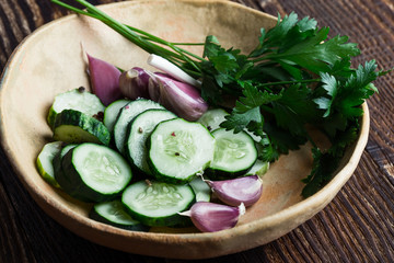 Bowl of freshly picked organic cucumbers and garlic, fresh vegetables salad