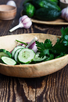 Bowl of freshly picked organic cucumbers and garlic, fresh vegetables salad
