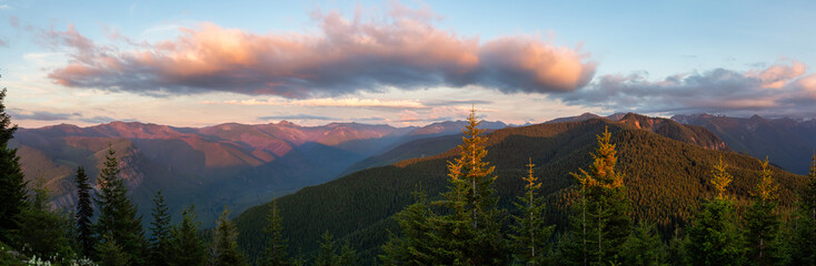 Beautiful Panoramic View of American Mountain Landscape during a vibrant and colorful summer sunset. Taken from Sun Top Lookout, in Mt Rainier National Park, South of Seattle, Washington, USA.