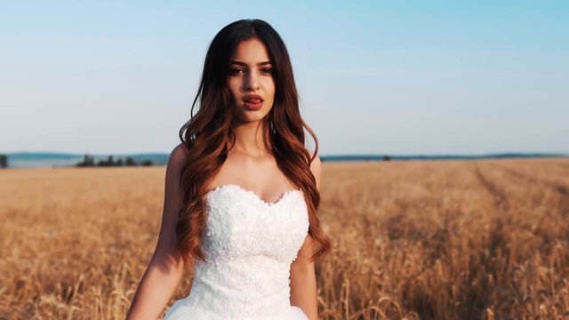 Beautiful bride in wheat field on sunset