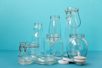 Glass jars standing on blue background. Eco friendly, reuse or zero waste concept.