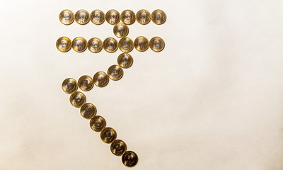 10 rupee indian currency coins are placed to form indian currency symbol