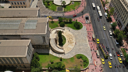 Aerial photo of iconic landmark neoclassic buildings of Academy, University and public Library in the heart of Athens historic centre with beautiful clouds, Attica, Greece