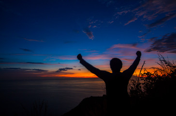 Fototapeta premium Silhouette Men love adventure travel photography. Black Rock View Point, Phuket Thailand Twilight evening in the tropics
