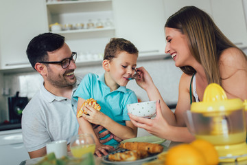 Family Eating Breakfast At Kitchen Table