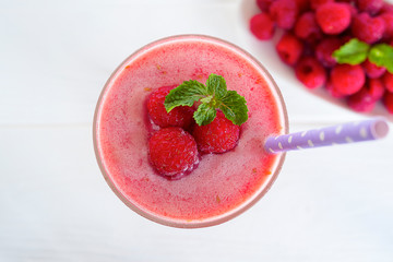 Raspberry smoothie red colorful fruit juice milkshake blend beverage healthy high protein the taste yummy In glass,drink episode morning on a white wooden background from the top view. 