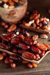 Various dried fruits and nuts in wooden dish.