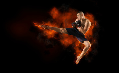 Fototapeta na wymiar MMA male fighter kick. Flames background