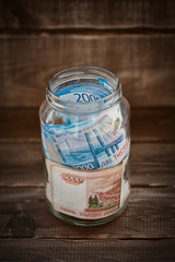 Russian banknotes in a glass jar