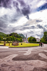 Obraz premium Christian cross on a background the Basilica of our Lady of the Rosary in Lourdes, France