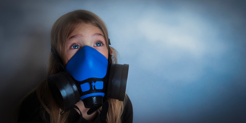 Young girl wearing gasmask, respirator portrait. Effects of worldwide air pollution, industrial...