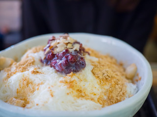 Patbingsu, ice dessert with almond toppings on bowl.