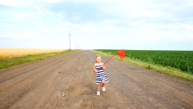 Child girl walking along a rural road