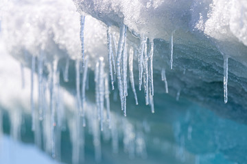 Icicles hanging from the base of the ice shelf in Svalbard - obrazy, fototapety, plakaty