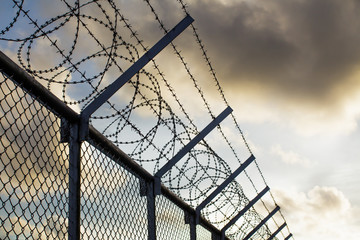 Background of prison warfare, barbed wire fence in Phuket Thailand - Powered by Adobe