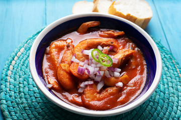 Mexican shrimp soup on blue background