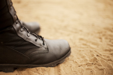 shoes on the beach. Boots on the sand. Bright background