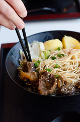 Closeup of a bowl of beef and vegetable stir fry.