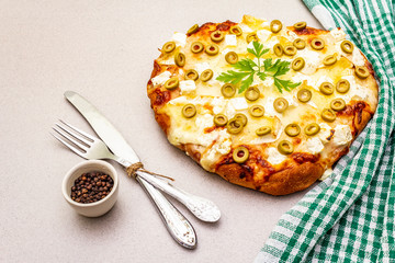 Italian focaccia with three types of cheese, green olives, black pepper and parsley