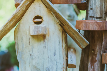 Hand made wooden bird house nest  in public Park , hand wood shelter for birds .