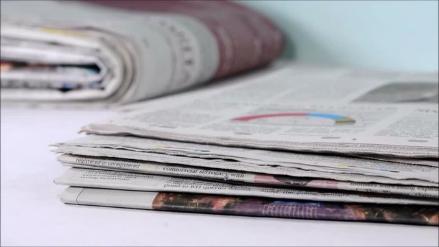Stack of newspaper on a desk