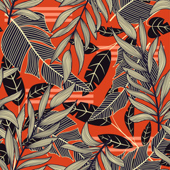 Obraz premium Trend abstract seamless pattern with colorful tropical leaves and plants on a red background. Vector design. Jungle print. Floral background. Printing and textiles. Exotic tropics. Fresh design.