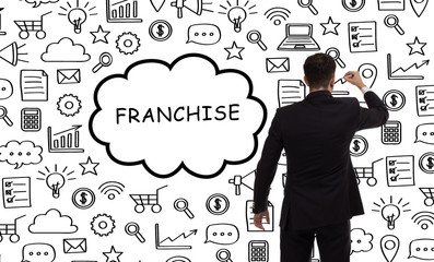 Business, technology, internet and networking concept. Young entrepreneur showing keyword: Franchise