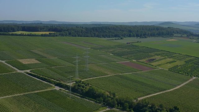 Aerial of Vineyards close to Mundelsheim in Germany.  Camera  pans slightly right and then left as it zooms out over vineyards.