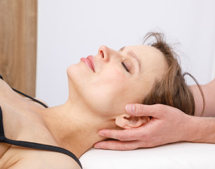 Woman receiving osteopathic treatment of her neck
