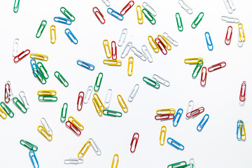 Fototapeta na wymiar colored paper clips on a white background