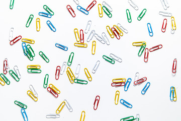 colored paper clips on a white background