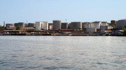 Obraz premium Plant for the processing of petroleum products and the production of fuel and lubricants. Fuel tanks on the shore.