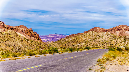 Fototapeta na wymiar Colorful and Rugged Mountains along highway SR 165 in El Dorado Canyon on the border of Nevada and Arizona. The canyon is part of the Lake Mead National Recreation Area in the USA