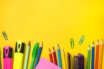 School supplies on yellow background. Top view. Copy space.