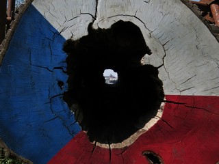 View from Vitkov Hill at Prague Castle Through Hole in a Tree Trunk Log