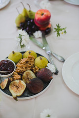 Beautifully decorated catering banquet table with different food snacks and appetizers with sandwich, caviar, fresh fruits on corporate party event or wedding celebration