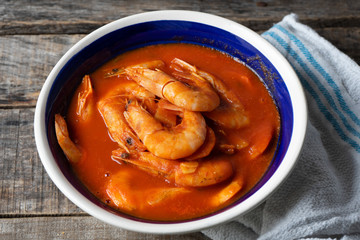Mexican shrimp soup on wooden background