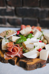 Mix cheese on wooden board with grapes. Top view.