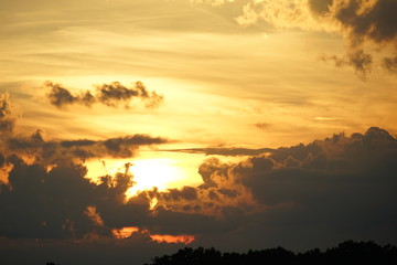 Fototapeta na wymiar Brilliant Orange and Gold Sunset with Clouds